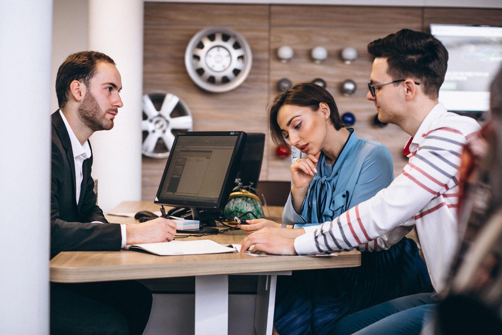 Car Dealership Meeting With Sales Agent And Customers