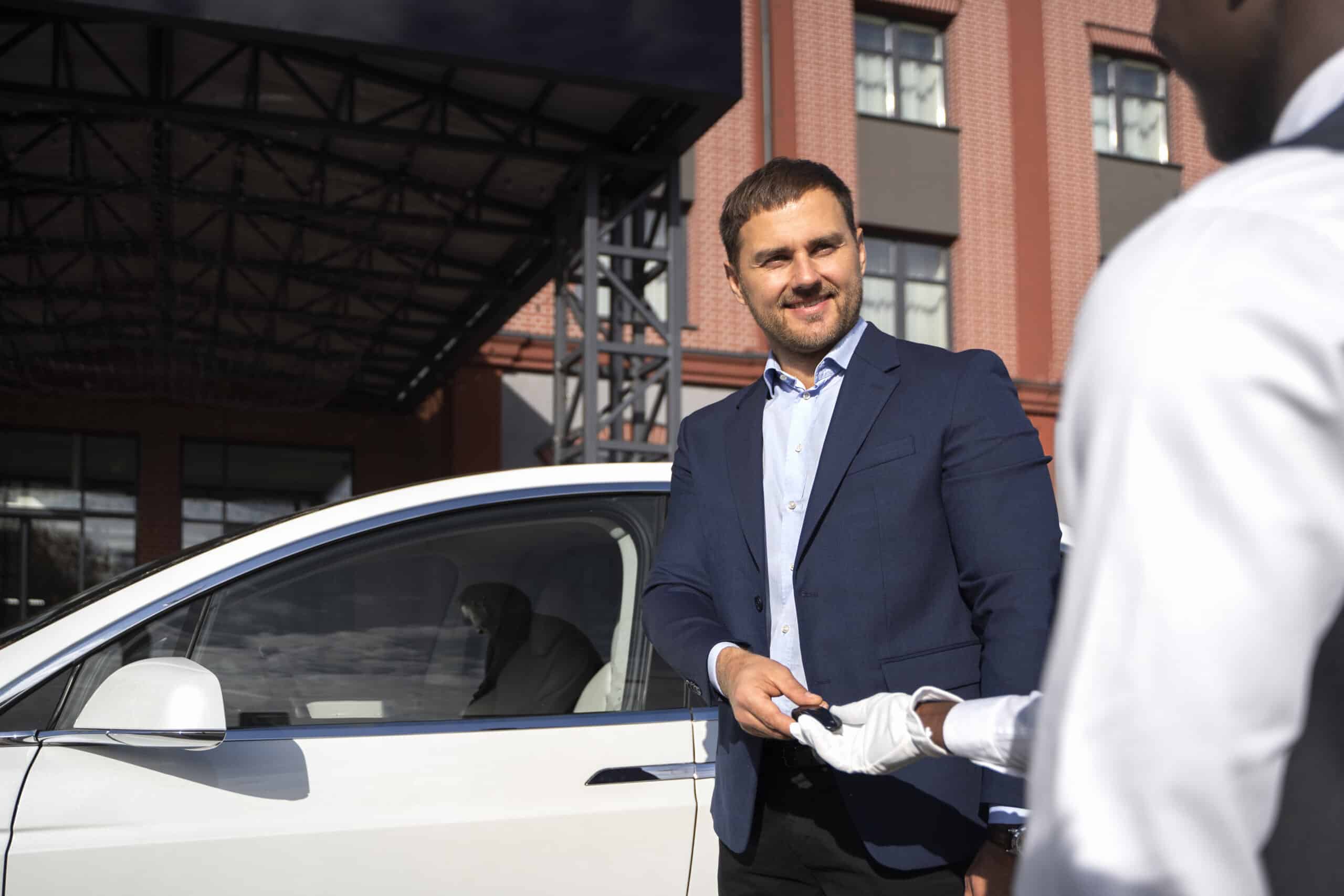 Side-View-Smiley-Man-Holding-Key, Car Dealer In Kenya